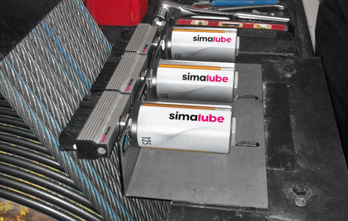 Several simalube lubricators oil and clean the lift ropes of a lift with the attached flat brush.