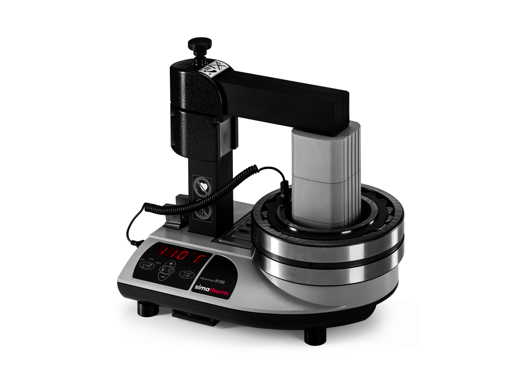 The simatherm IH 090 induction heater heats a medium-sized deep groove ball bearing over the coil. The target temperature is set to 110 °C. 